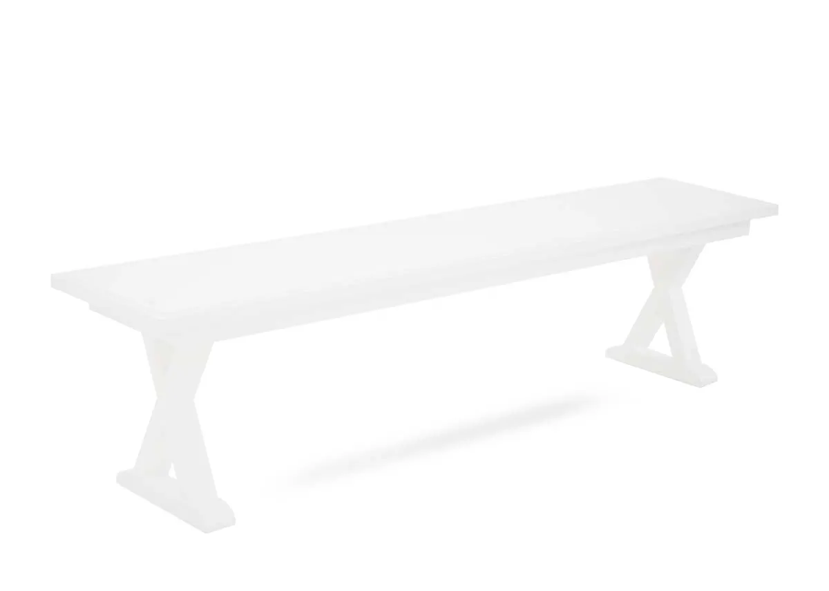 A white rectangular dining bench from EZ Livings Hampton range. Angled view of trestle style base