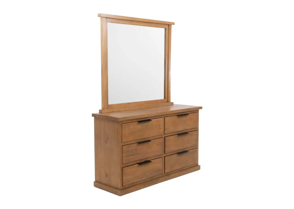 An angled front view of a light brown wooden dresser with six black handled drawers and a large rectangular mirror on top.