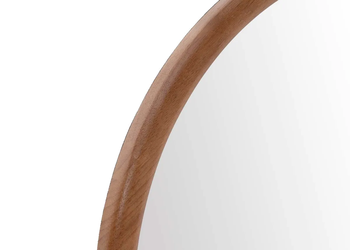 An oval wall mirror with wooden frame from EZ Livings Carson range.Closeup of wood frame
