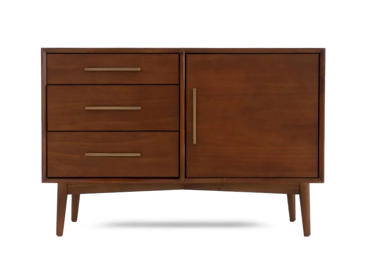 A dark pine sideboard with a single door on the right and three vertically stacked drawers on the left all with brass pulls.