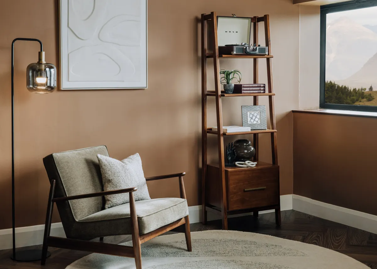 A lifestyle image of the Jordan armchair with a Leya display unit with plants and ornaments.