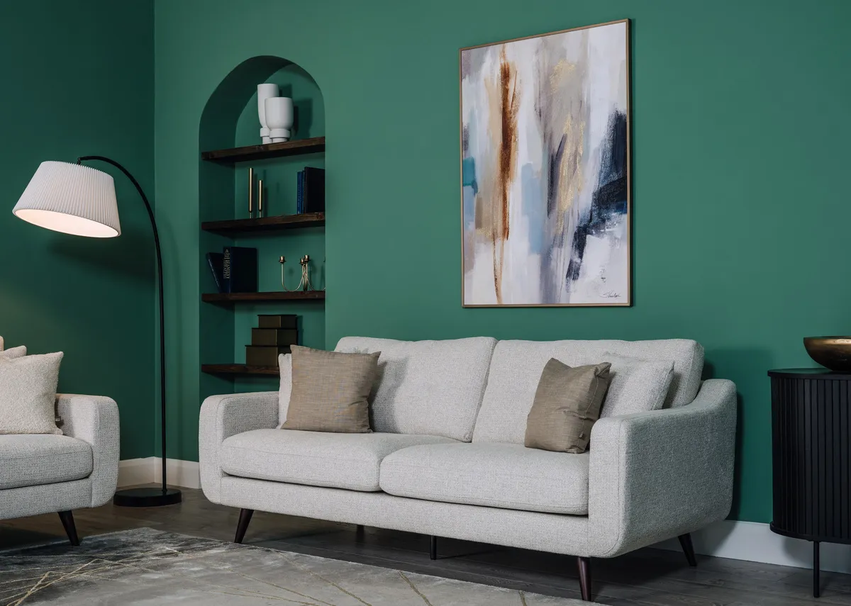 A lifetsyle image of the Bandon silver sofa and armchair with Nola sie and Arc floor lamp.
