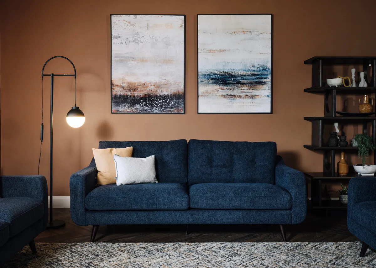 A lifestyle image of the Bandon navy sofa with Misty View canvas and Casper lamp.