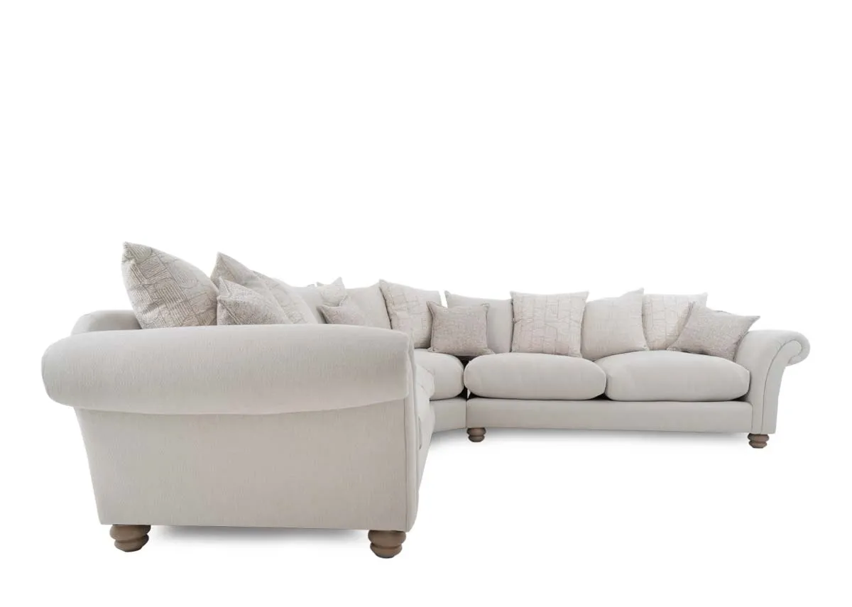 An extra large cream fabric pillowback corner sofa from EZ Livings Paloma range. Side view