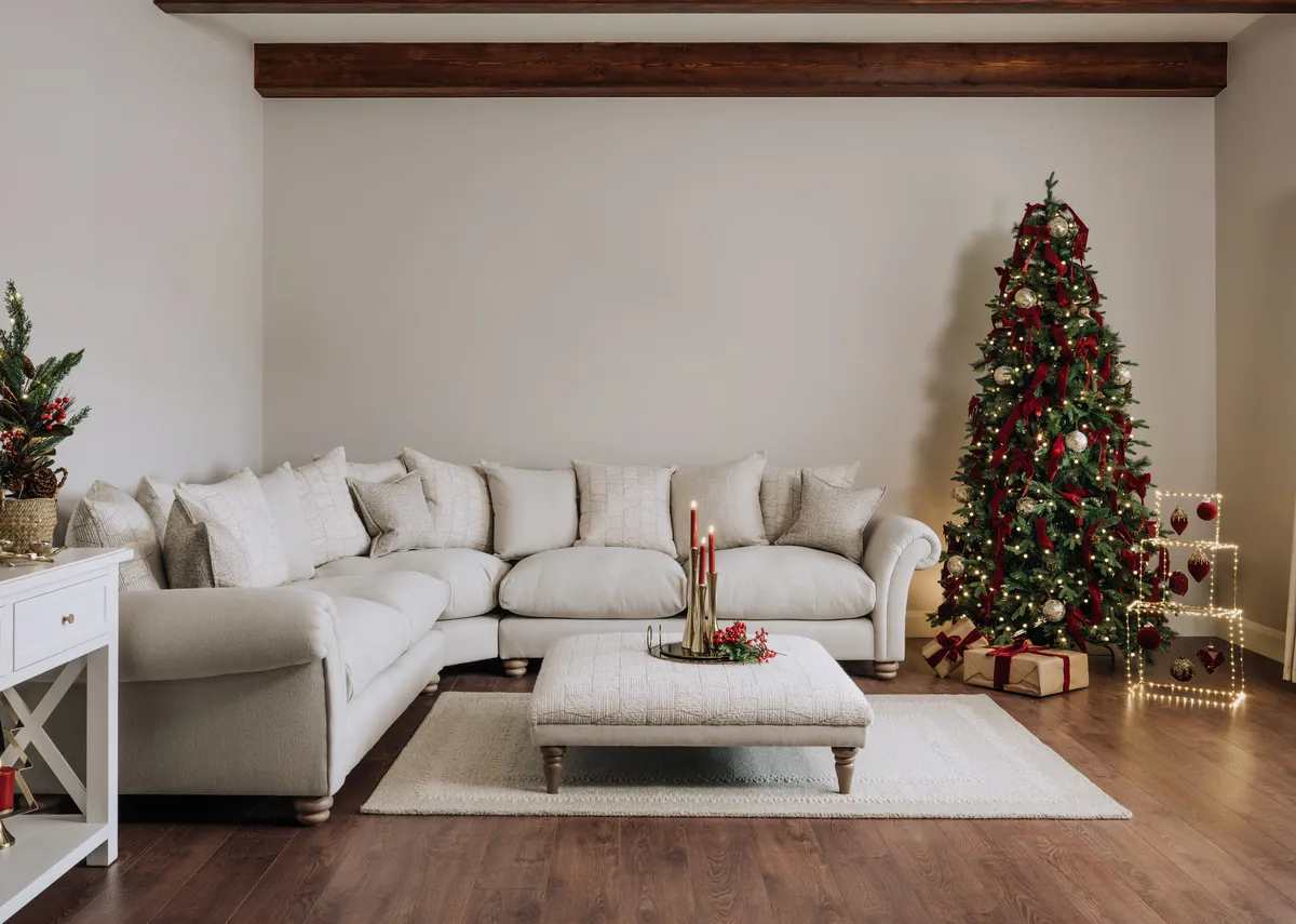 A lifestyle image of the Paloma Corner sofa with footstool and Austria Christmas tree