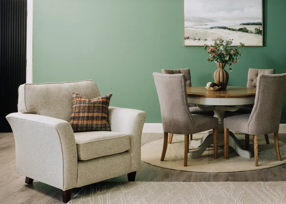A lifetsyle image of the Kilronan armchair with check cushion and Georgia dining table.
