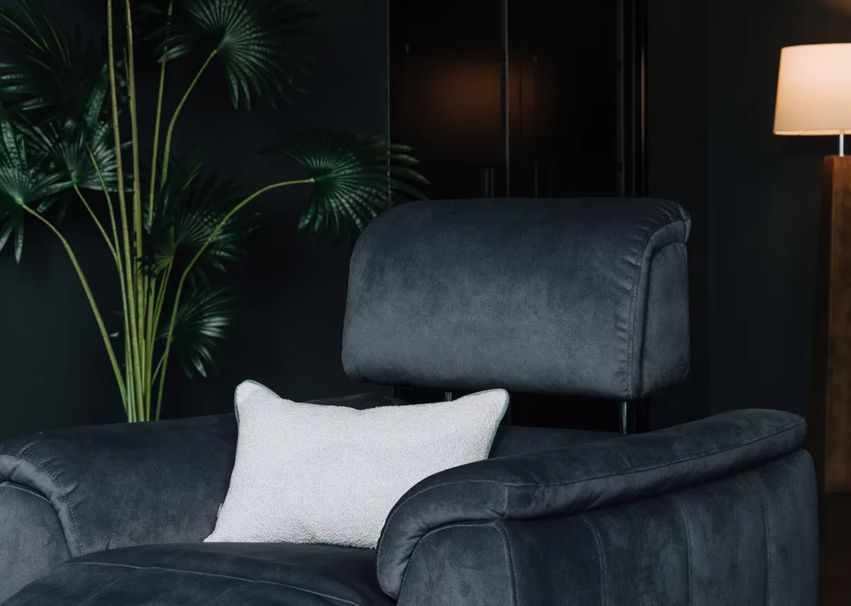 A dark grey power recliner from EZ Livings Madsion range. Closeup of adjustable headrest.