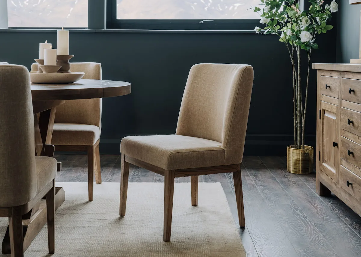A lifestyle image of the Naxos cream oak dining chair with the Naxos table and sideboard.