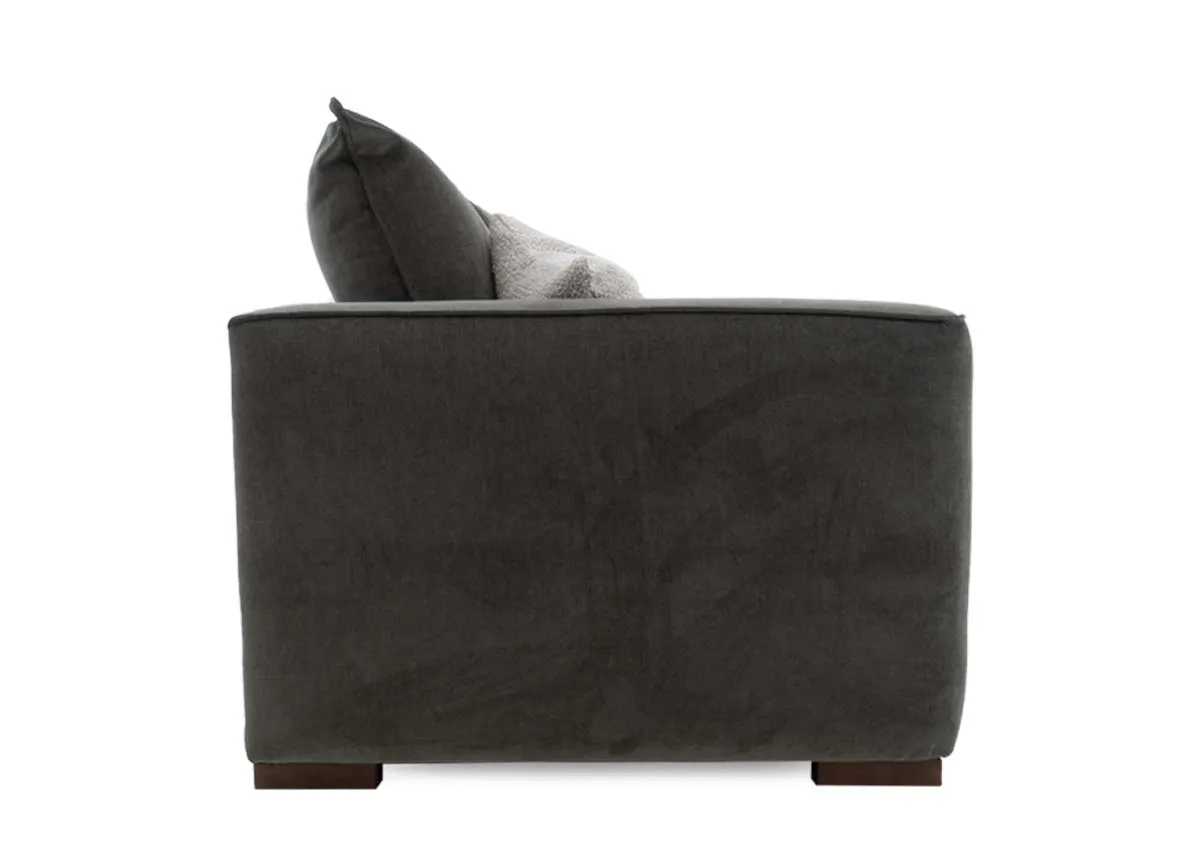 A 2 seater sofa in spruce green fabric from EZ Livings Lucius range. Side view of high arms