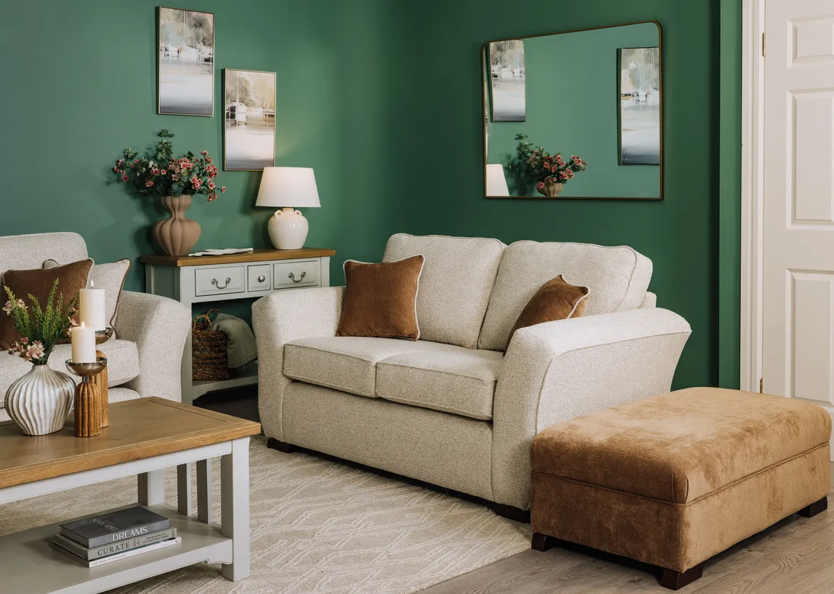 A lifestyle image of the Kilronan 2 seater sofa with footstool and Georgia console and coffee table.