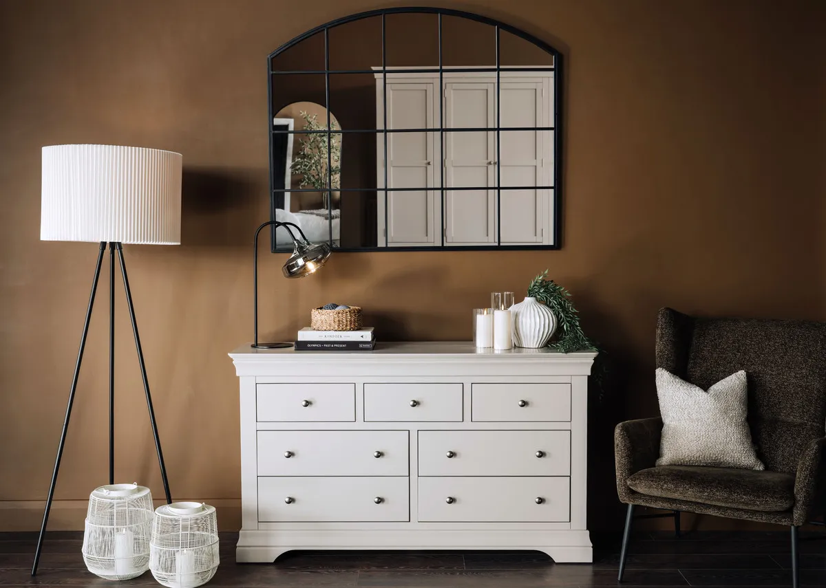 A lifestyle image of the Dove dresser with Meera mirror and 2 Motijo candle holders