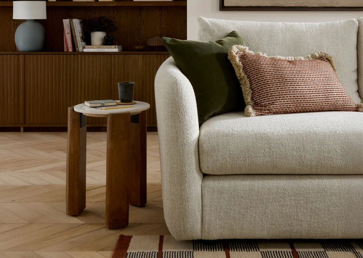 A cream boucle large rhf corner sofa with 6 scatters from EZ Livings Carnaby range.Front view