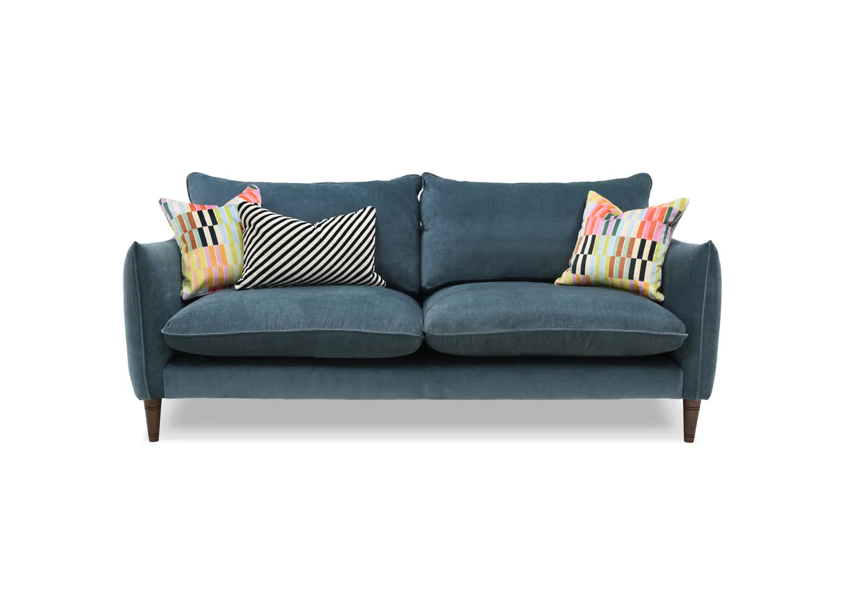 A 4 seater blue fabric sofa from EZ Livings Kenmare range. Front view of striped bolster and 2 multi stripe cushions.