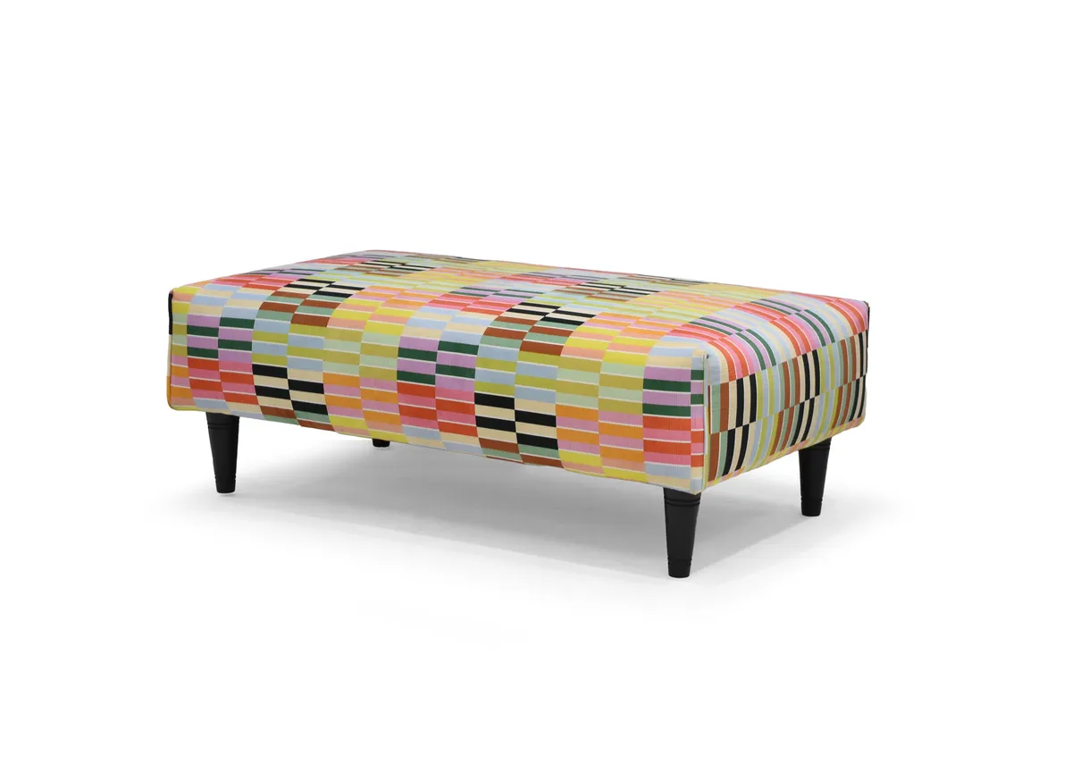 A rectangular footstool in a multi colour strip fabric from EZ Livings Kenmare range. Angled view