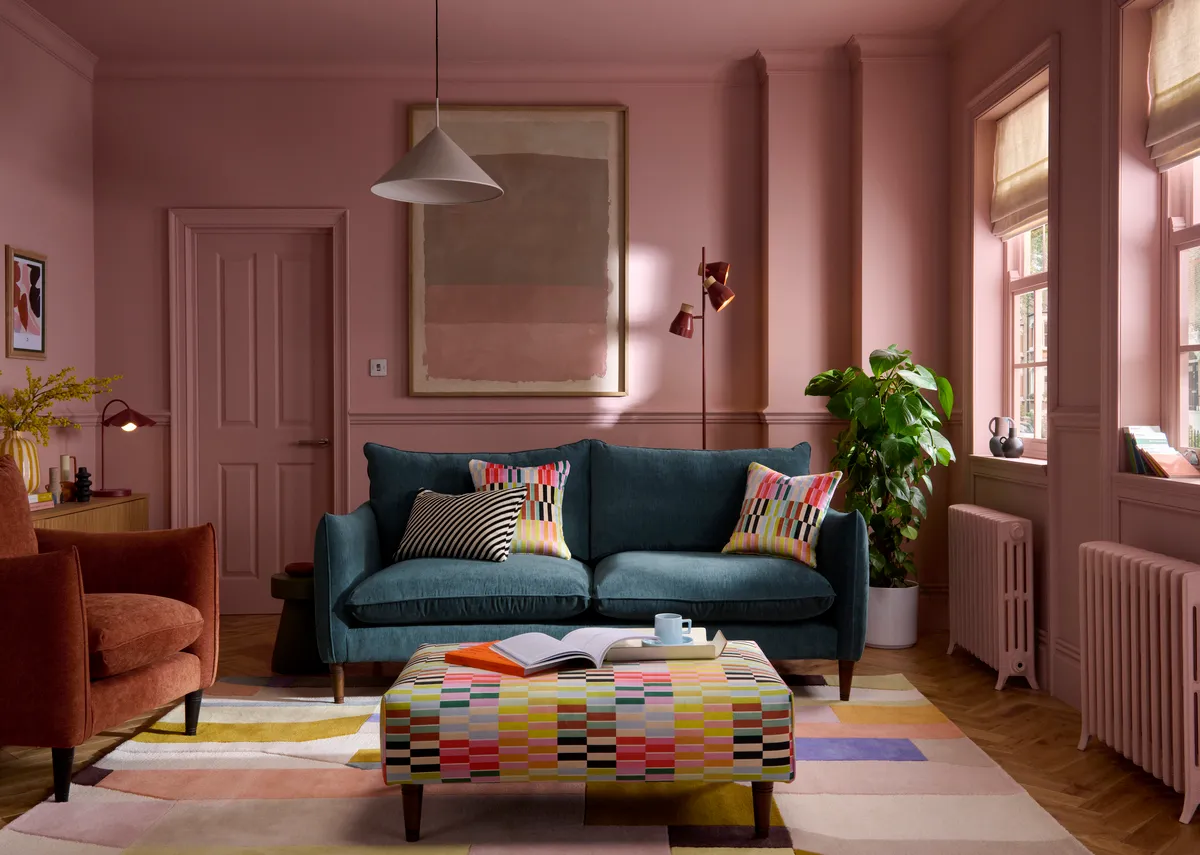 A lifestyle image of the Kenmare sofa with multi stripe footstool