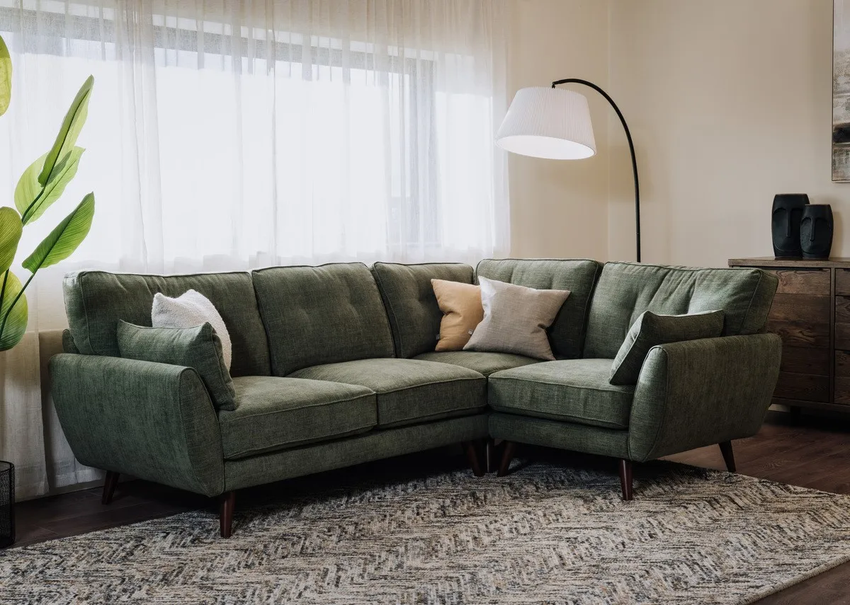 A lifestyle image of the Caoimhe corner sofa with Arc floor lamp and savannah rug.
