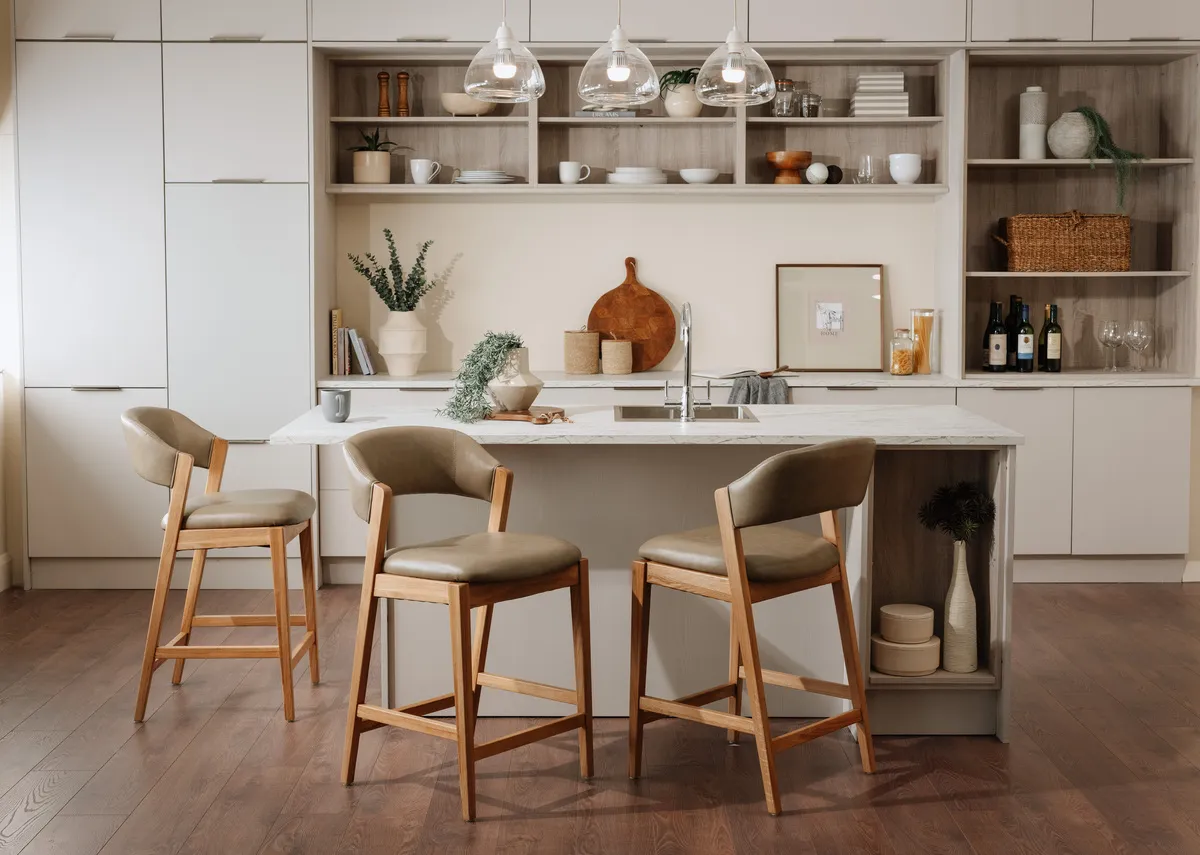 A lifestyle image of 3 Renvyle bar stools around a kitchen island in a kitchen