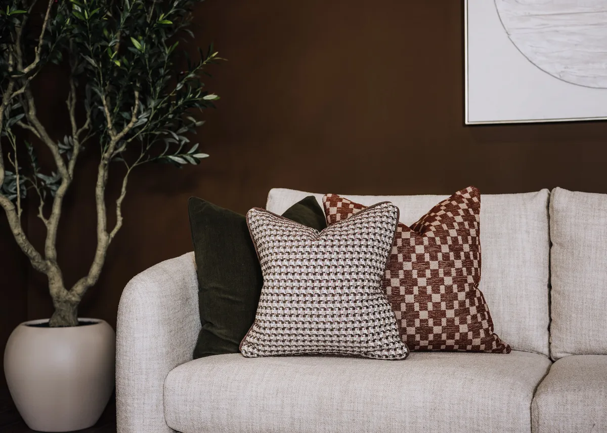 A cream boucle large rhf corner sofa with 6 scatters from EZ Livings Carnaby range.Front view