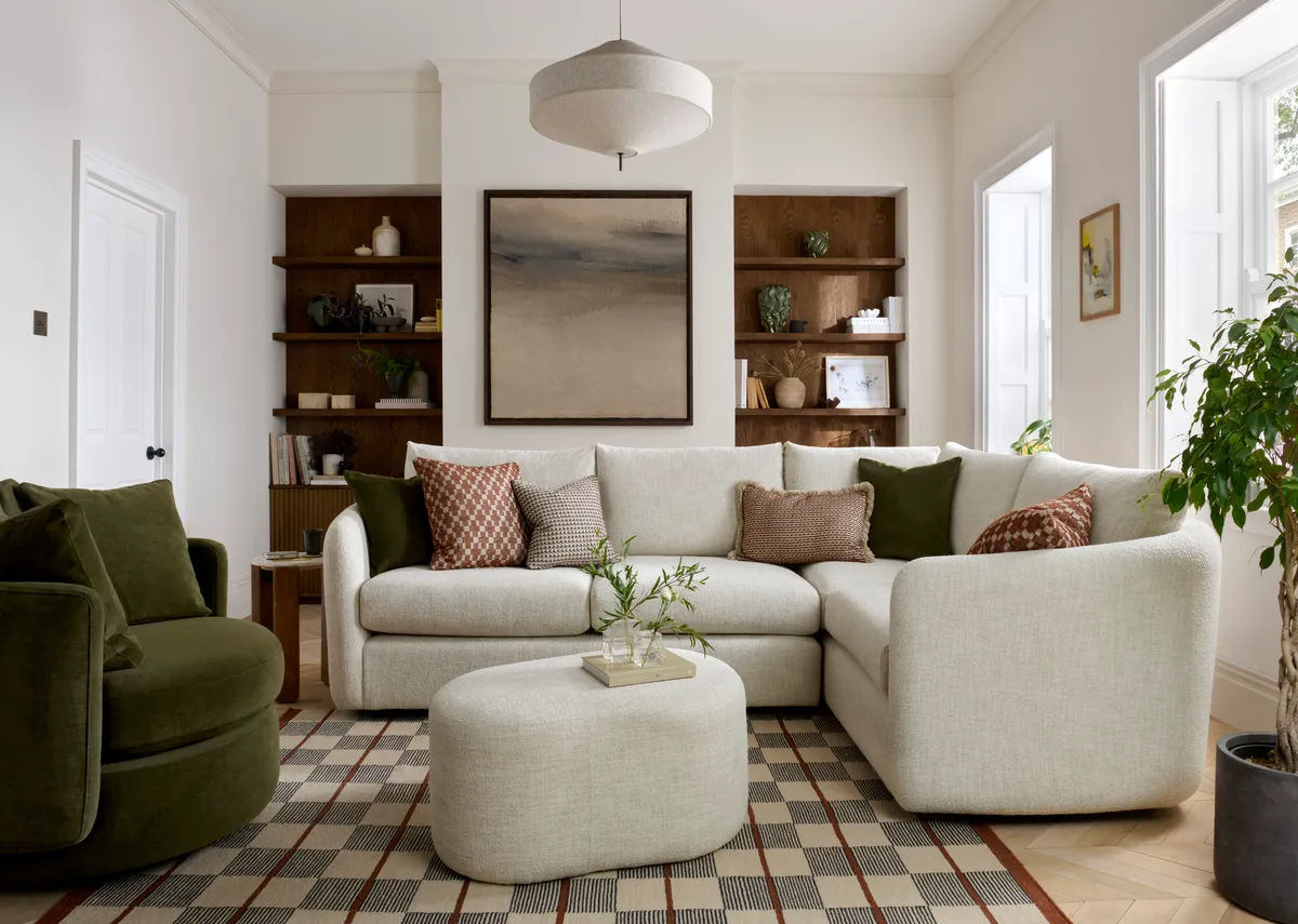 A cream boucle large rhf corner sofa with 6 scatters from EZ Livings Carnaby range.Front view