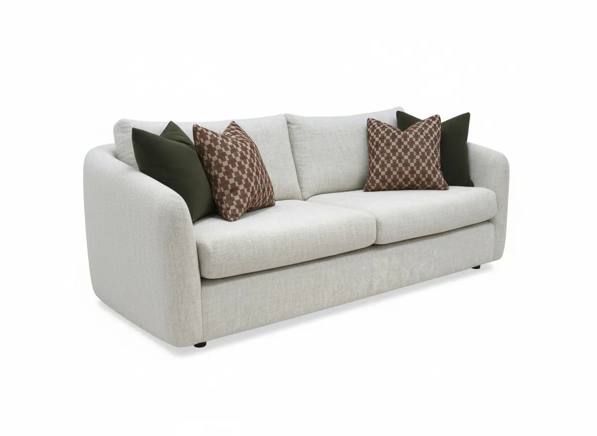 A cream boucle medium sofa with 4 scatters from EZ Livings Carnaby range. Angled view of curved sofa.