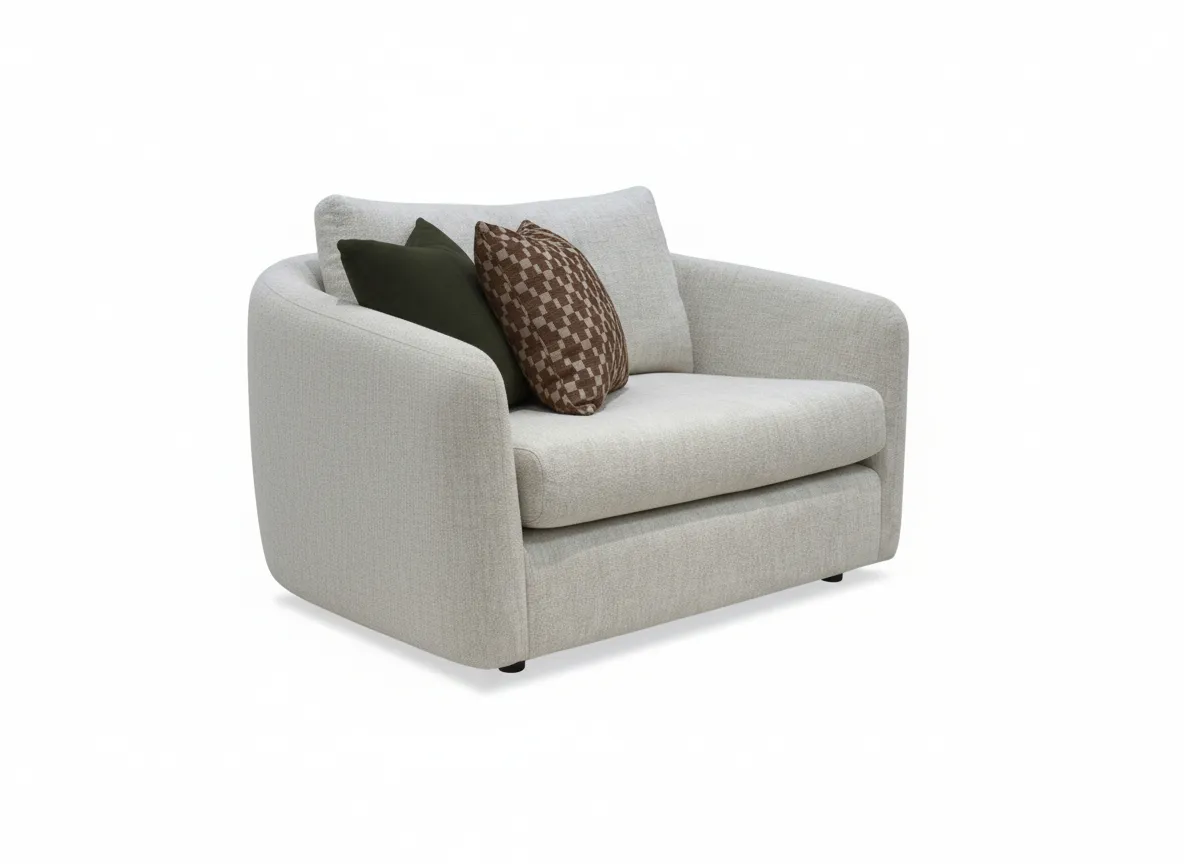 A cream boucle cuddler with 2 scatters from EZ Livings Carnaby range. Angled view of larger armchair with a green and a rust accent cushion.