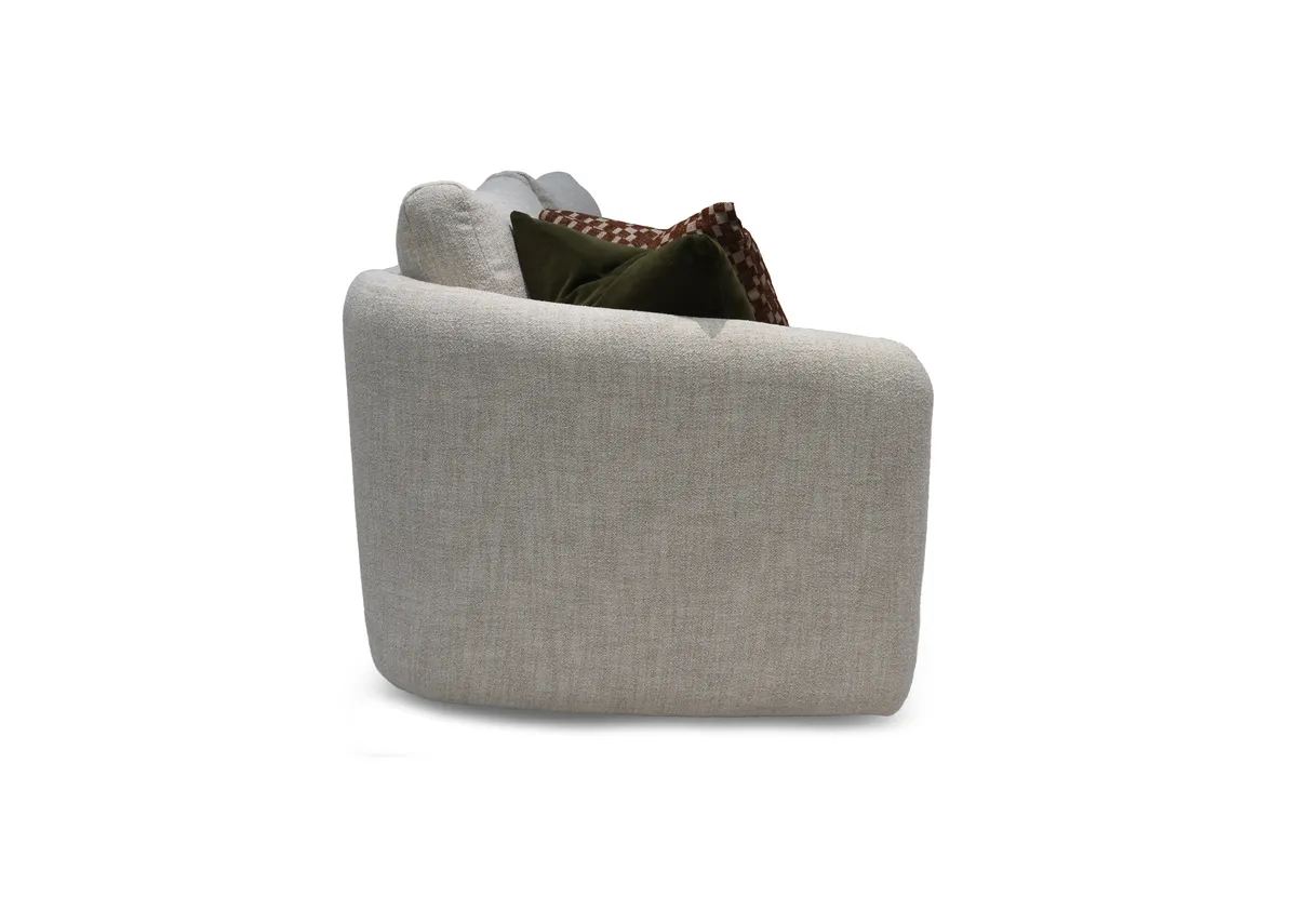 A cream boucle cuddler with 2 scatters from EZ Livings Carnaby range. Side view