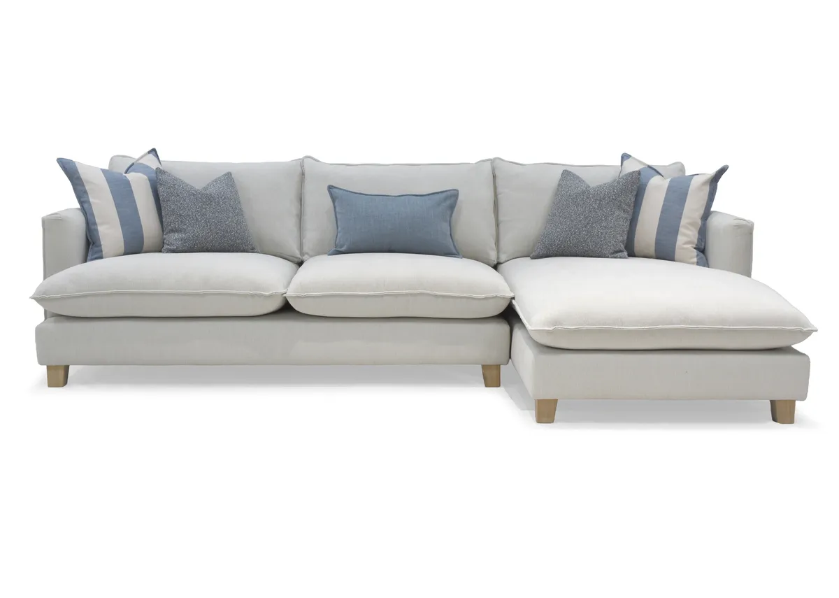 A beige linen rhf corner chaise with oak feet from the Vogue range. Back view of large frame