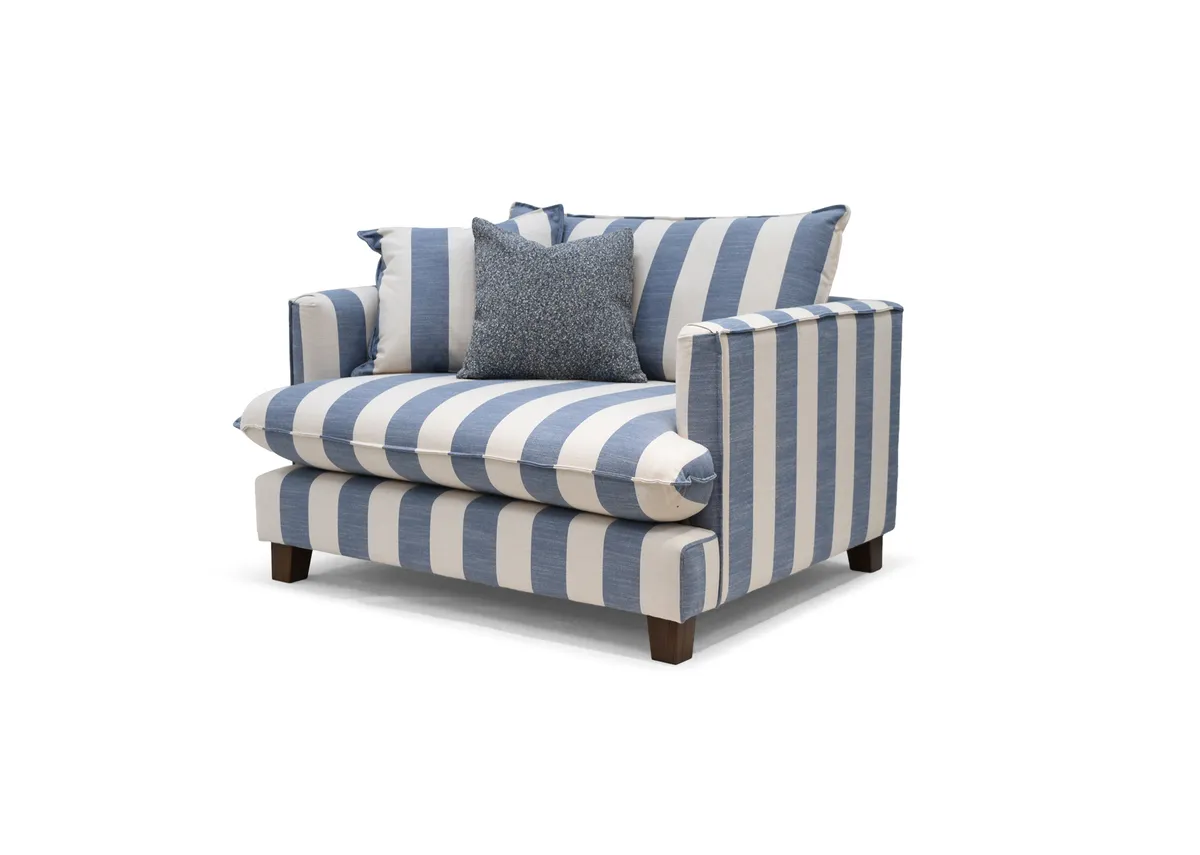 A blue & white stripe cuddler from EZ Living Furnitures Howth range. Angled view of foam padded seat and arms