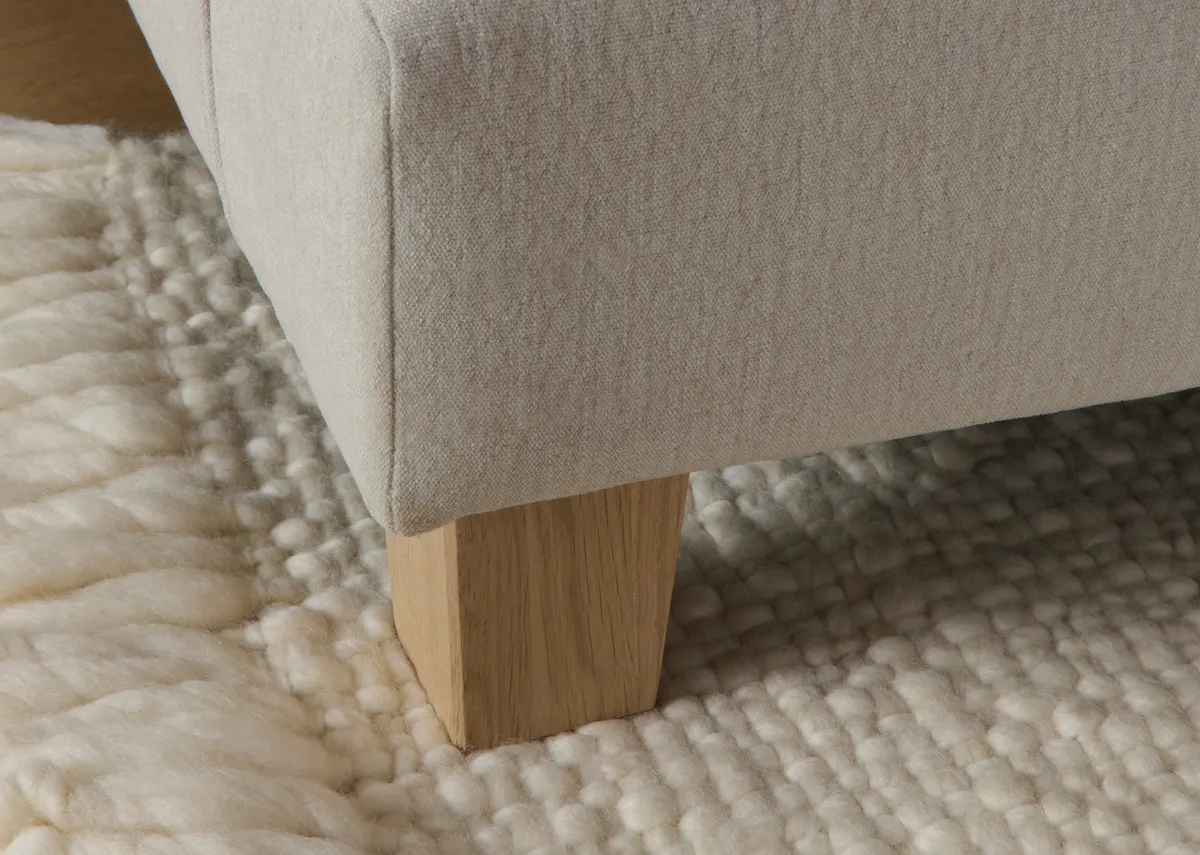 A cream 2 seater sofa from EZ Livings Howth range. Back  view with high cushions and oak feet.