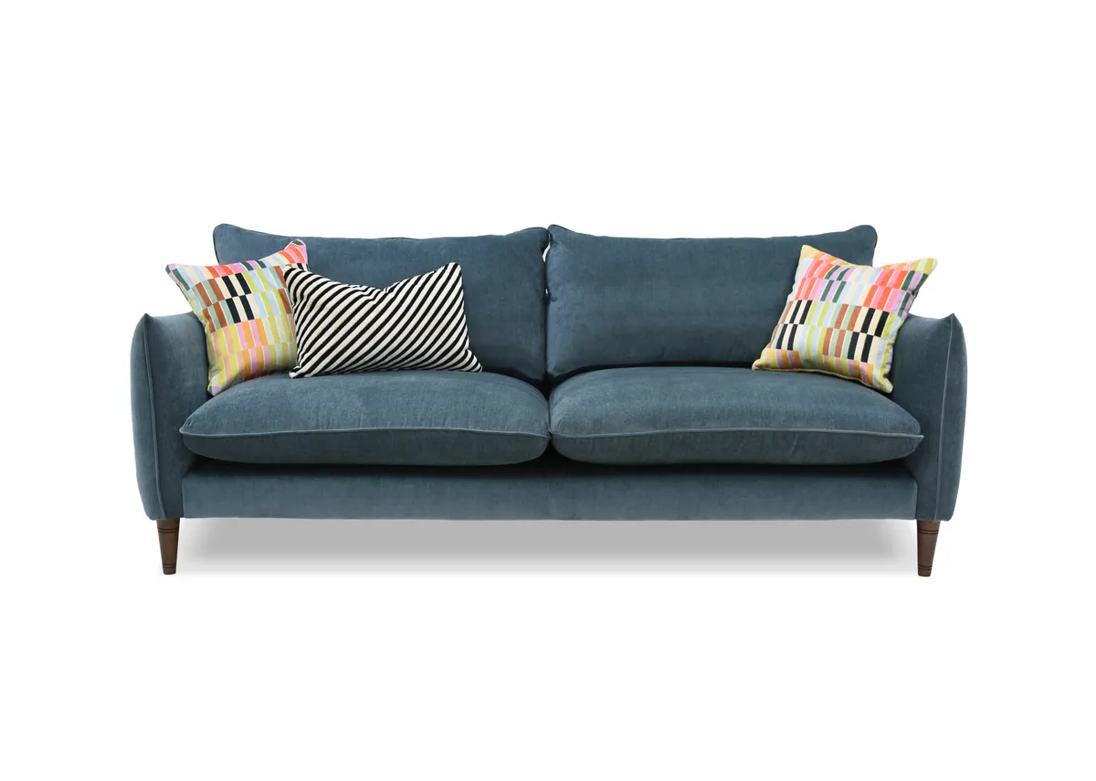 A 4 seater blue fabric sofa from EZ Livings Kenmare range. Front view of striped bolster and 2 multi stripe cushions.