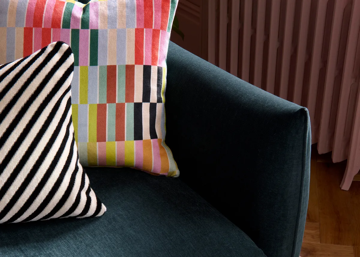 A lifestyle image of the Kenmare sofa with a closeup view of the cushion pattern.A lifestyle image of the Kenmare sofa with a closeup view of the cushion pattern.