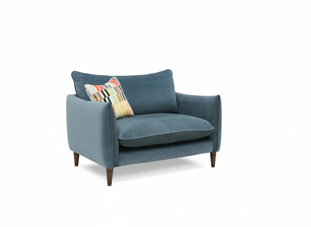 A blue fabric cudller with multi color cushion. Angled view
