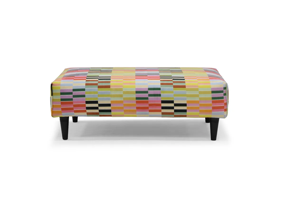 A rectangular footstool in a multi colour strip fabric from EZ Livings Kenmare range. Front view
