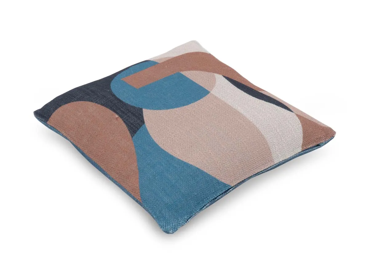 A blue geo print cushion with terracotta and pink shapesAngled view