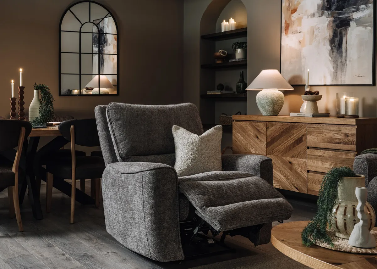 A lifestyle image of the Annalee swivel recliner with the Ellipse sideboard and coff table