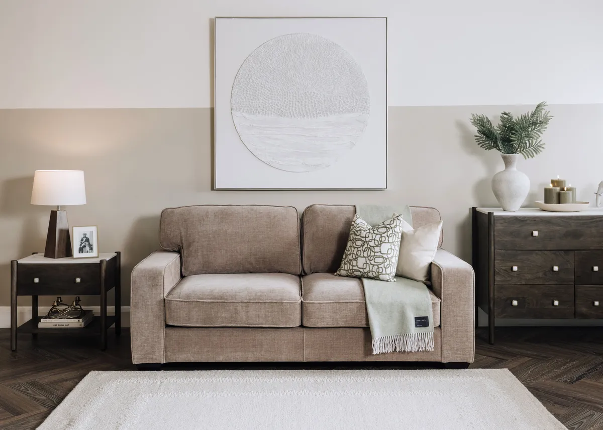 A beige fabric sofa from EZ Living Furnitures Nevada range. Angled view of sofa as bed