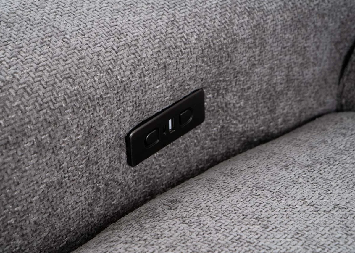 A grey fabric recliner from EZ Livings Ashbrook range.  Closeup of the usb port and reclining button on the inside of the arm