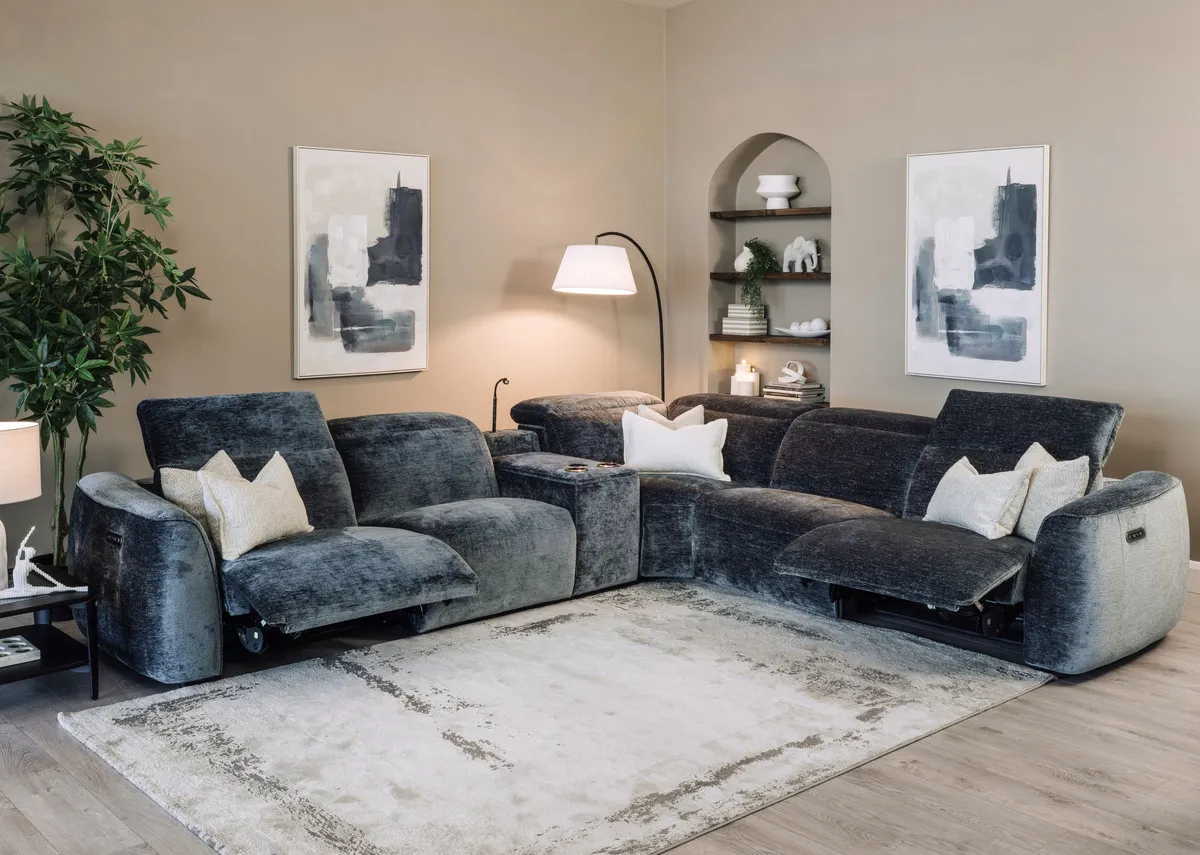A teal fabric corner sofa with 2 seater corner and 2 seater from EZ Livings Preston range. Anngled view with seats reclined and head tilt lifted.