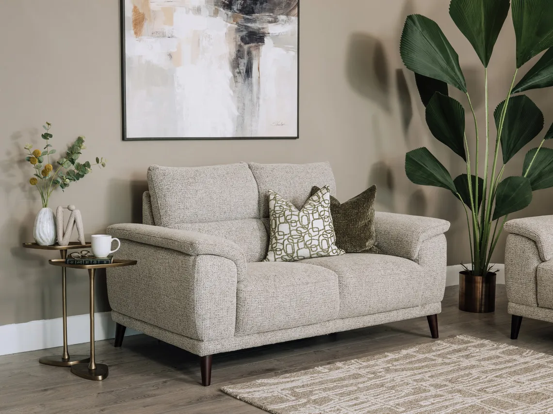 A lifestyle image of the Savoy 2 seater with daman btables inspire canvas and raleigh rug.