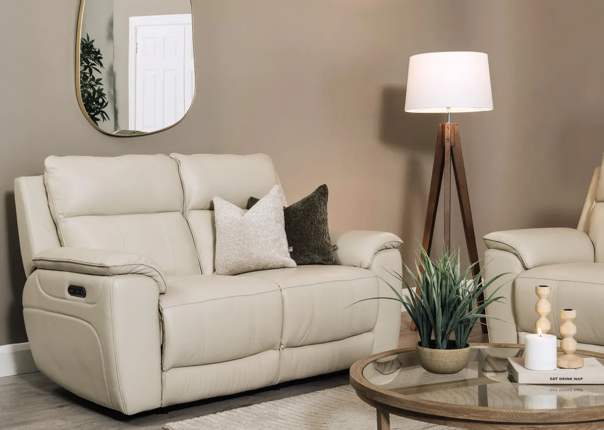 A lifetsyle image of the Aura leather 2 seater with Alexis tables and Delfina mirror.