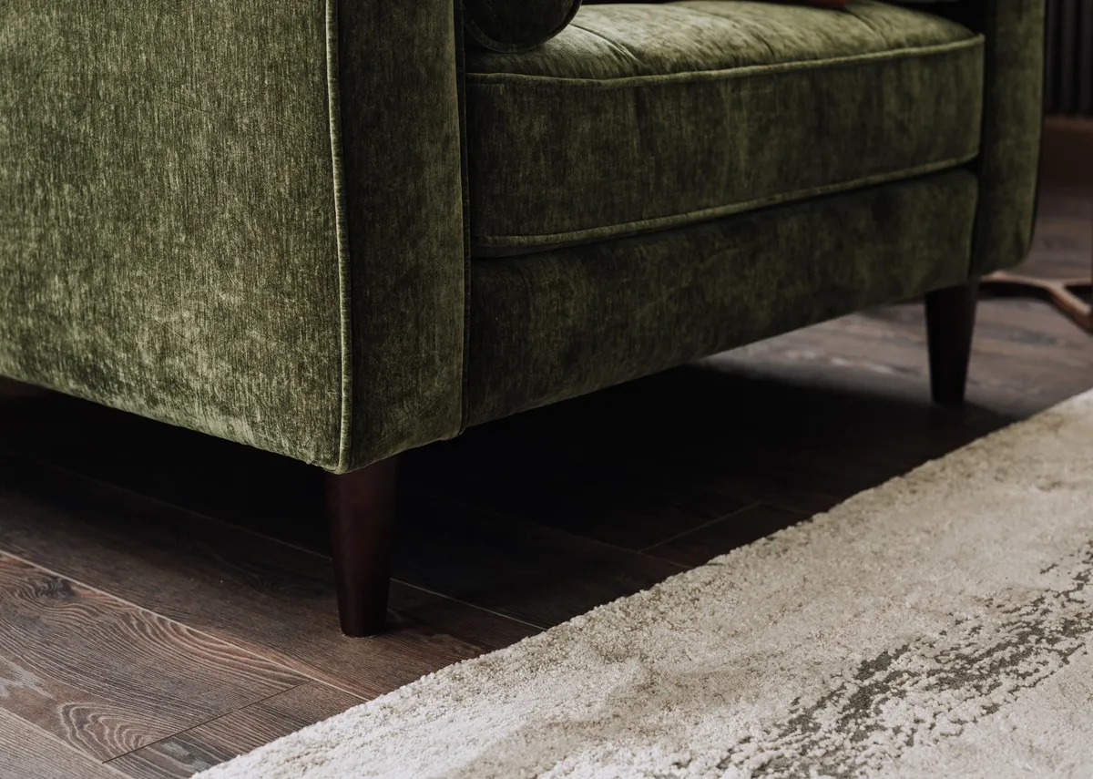 A green fabric armchair from EZ Living Furniture genoa range. Front view of low back and arms