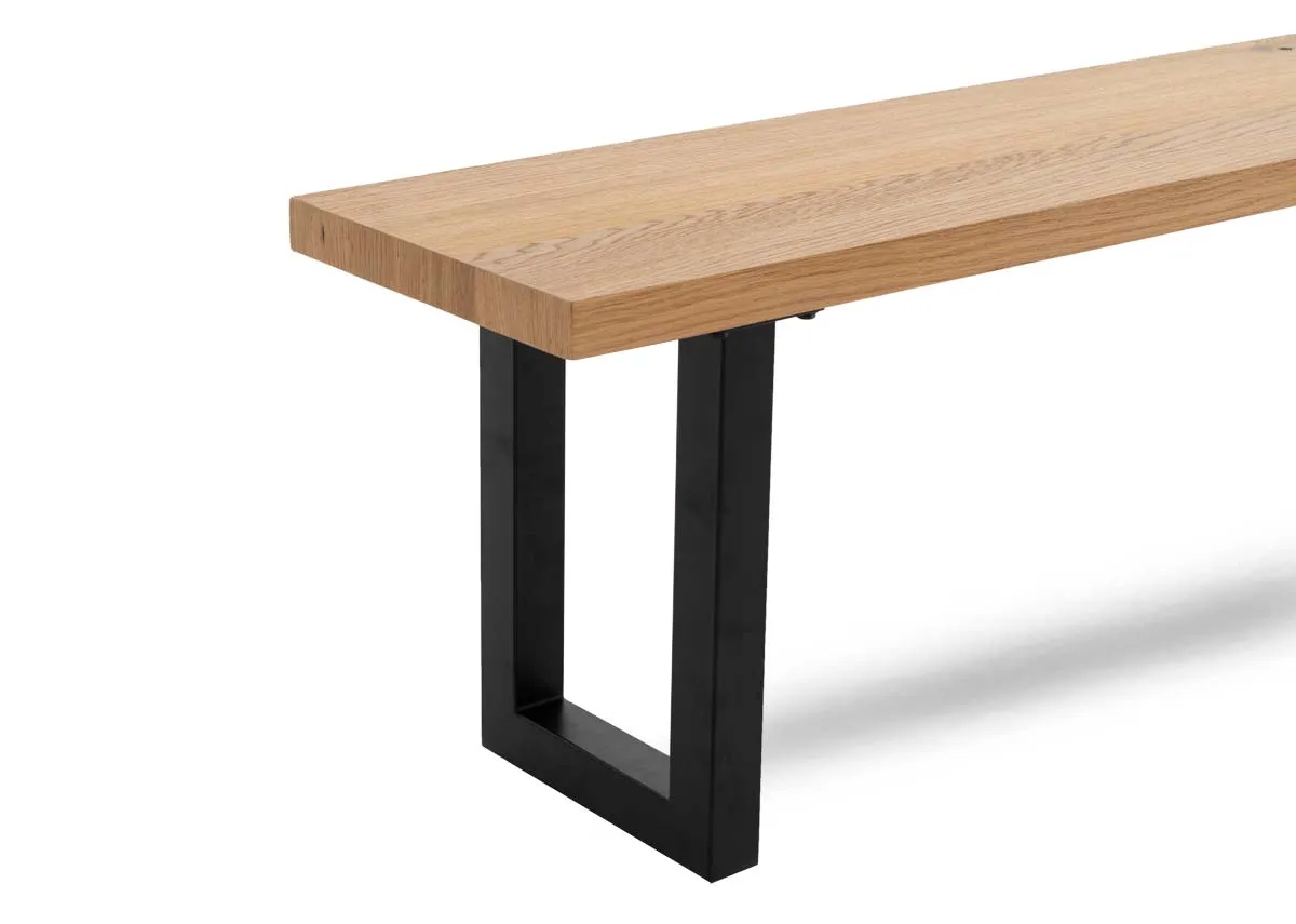 An oak dining bench with black metal base from EZ Livings Montana range.Closeup of textured wood finish.