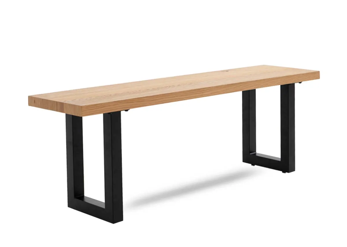 An oak dining bench with black metal base from EZ Livings Montana range. Angled view