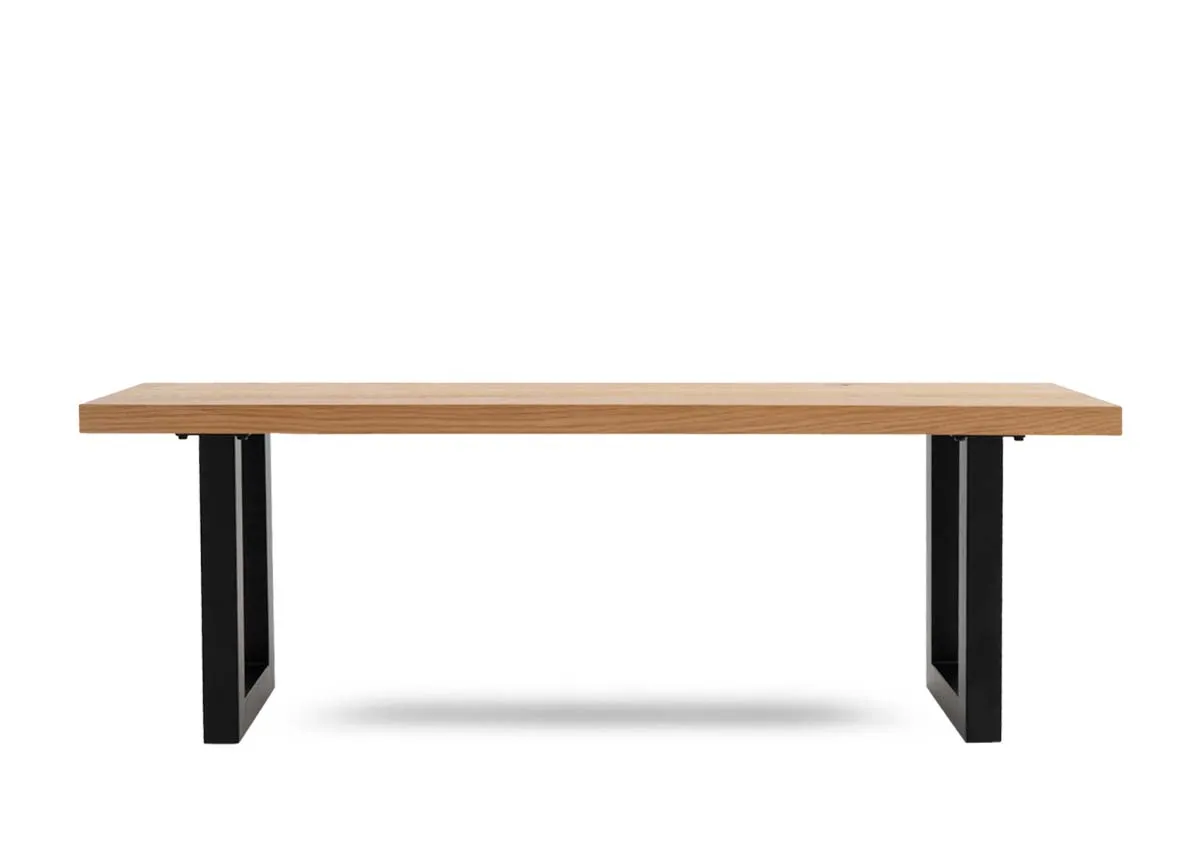 An oak dining bench with black metal base from EZ Livings Montana range.Front view shows thick wood top.