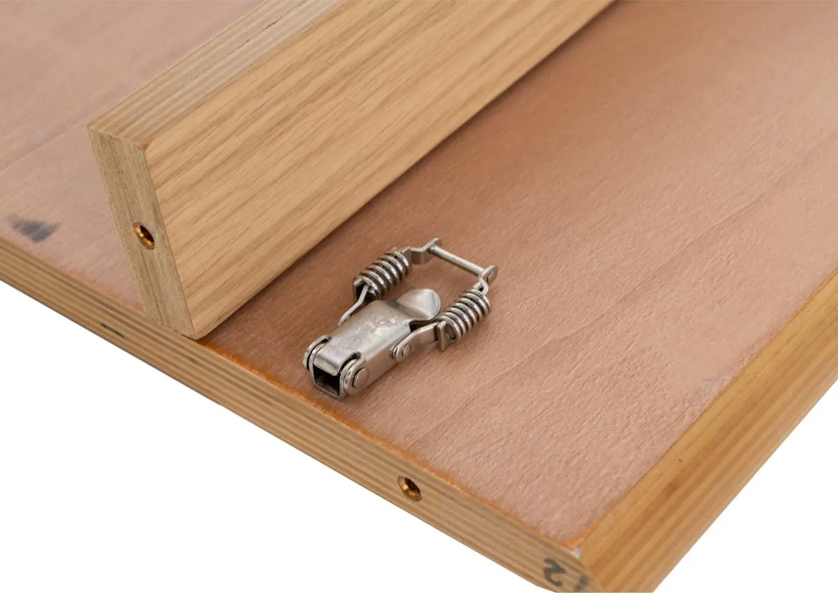 A closeup of the Anton extendable table shows latch for holding leaf in place.