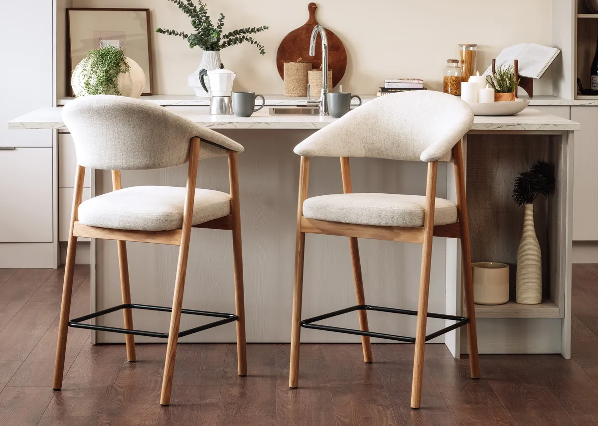 A lifestyle image of the Elk Counter bar stools with cream seat at a kitchen island