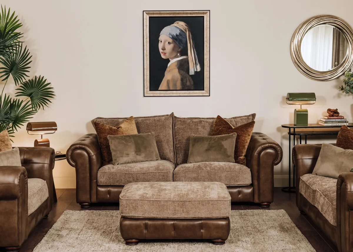 A lifestyle image of the Nepal footstool with the matching 2 seater sofa with Girl with a Pearl earing picture.