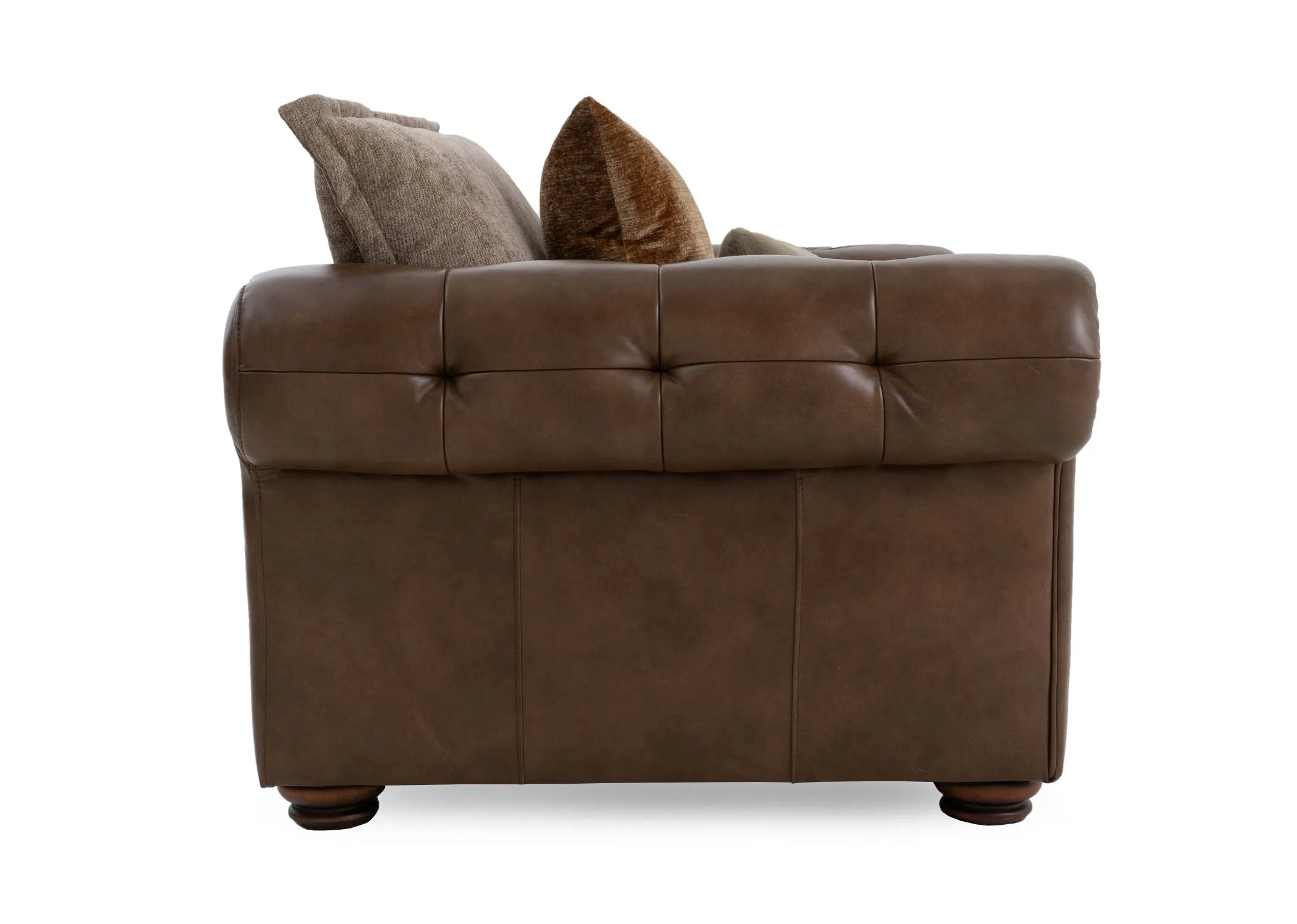 A brown cuddler with leather chesterfield frame and beige fabric seat and back cushion from EZ Livings Nepal range.Side view of scrolled arms