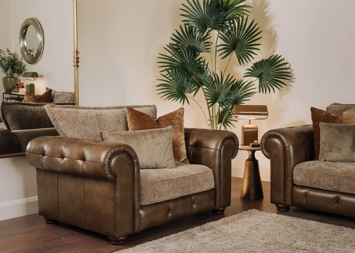 A lifestyle image of the Nepal armchair with the pyramid table and Keley gold mirror.