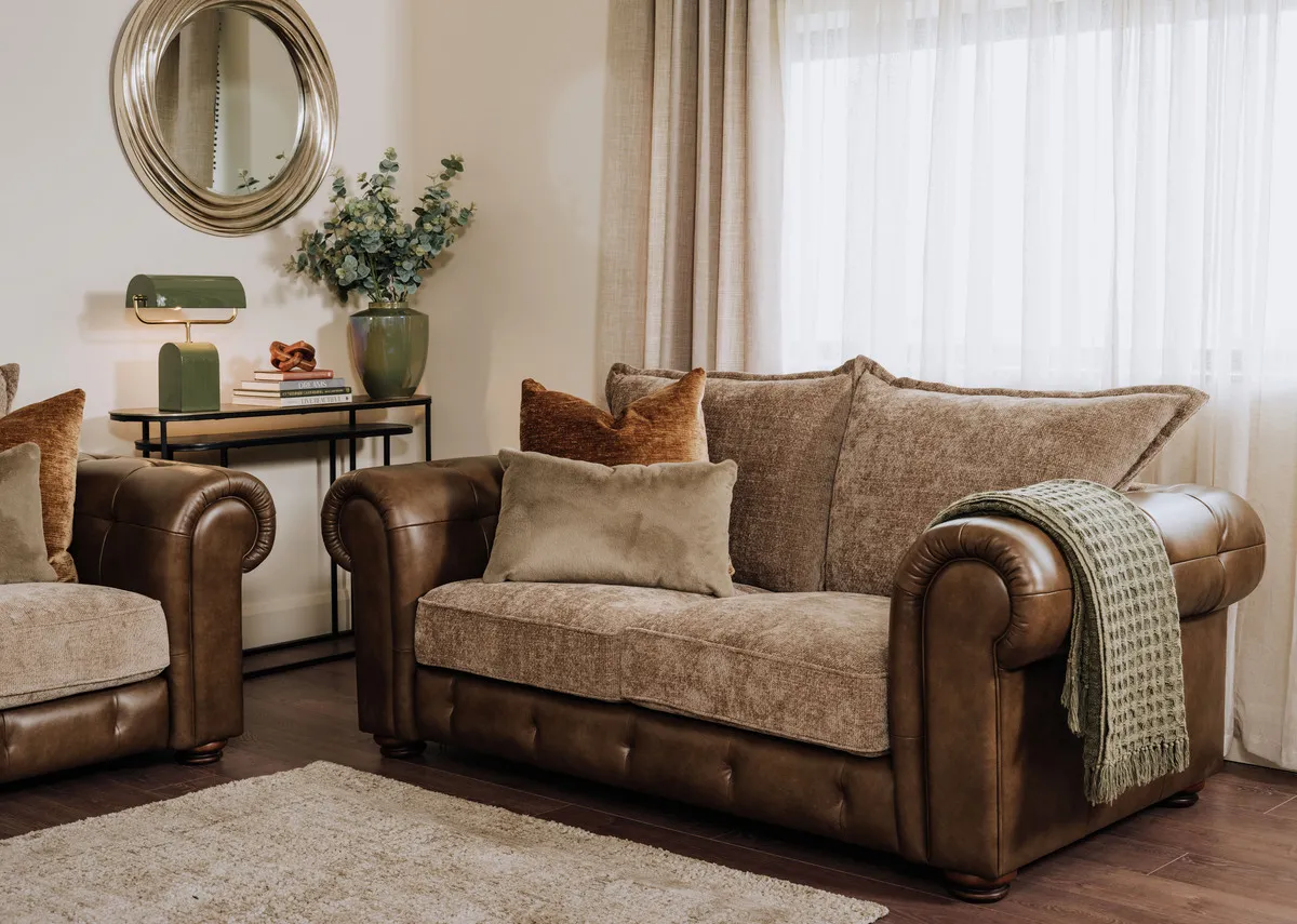 A lifestyle image of the Nepal 2 seater sofa with Charleville rug and Pyramid tables.